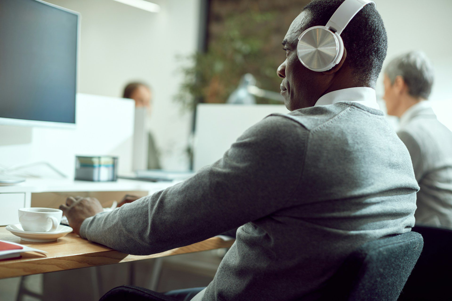 A person in front of a computer monitor