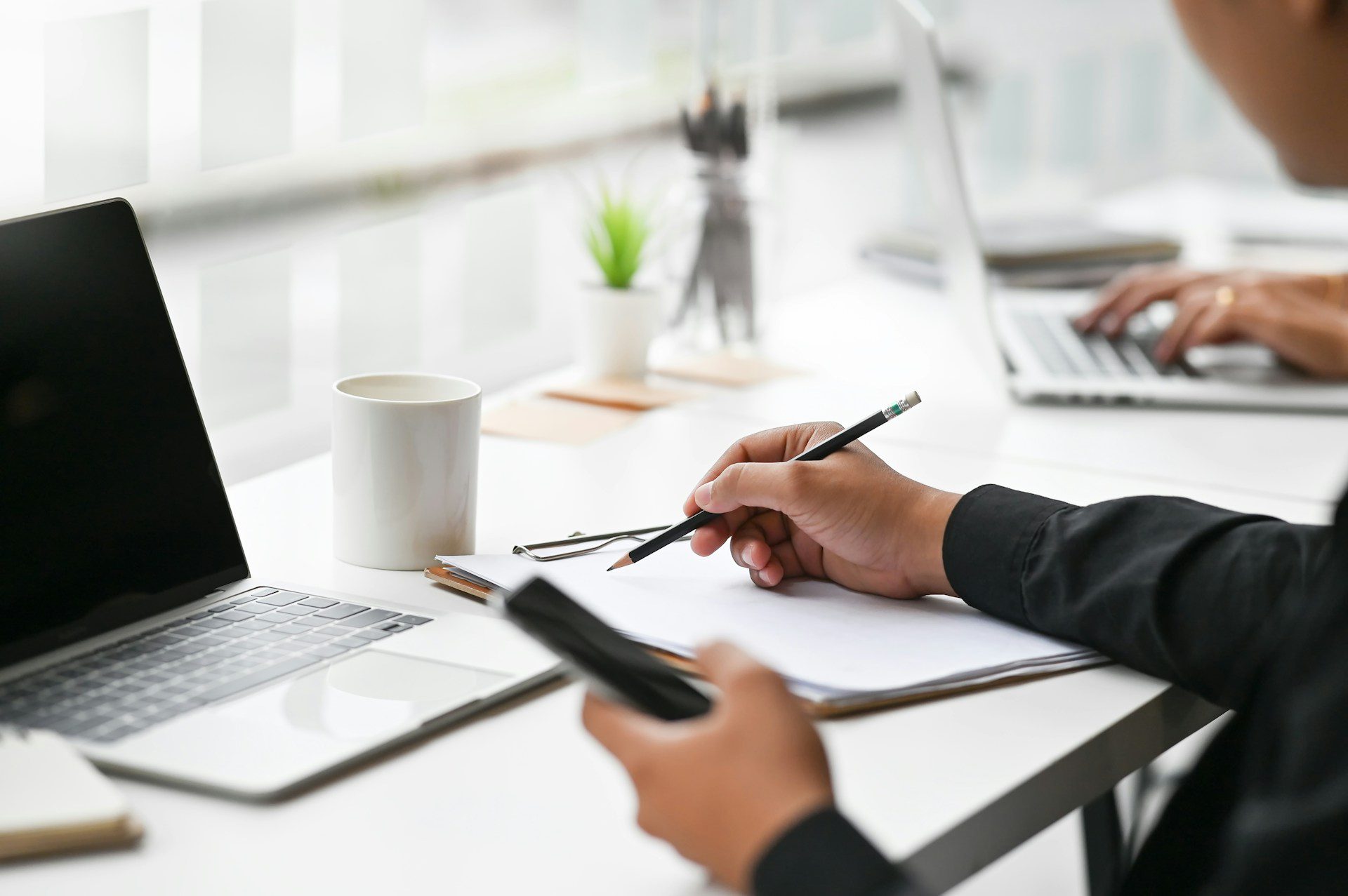 A person writing on a paper